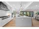 Modern kitchen with large island and stainless steel appliances at 8030 Midnight Pass Rd, Sarasota, FL 34242
