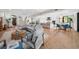 Open concept living area with hardwood floors, comfy seating and kitchen views at 8030 Midnight Pass Rd, Sarasota, FL 34242