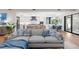 Bright living room with sectional sofa, hardwood floors, and access to patio at 8030 Midnight Pass Rd, Sarasota, FL 34242