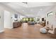 Open concept living room with hardwood floors and access to balcony at 8030 Midnight Pass Rd, Sarasota, FL 34242