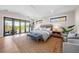 Spacious main bedroom with a king-size bed, private access to a balcony, and a sitting area at 8030 Midnight Pass Rd, Sarasota, FL 34242