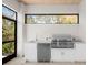 Outdoor kitchen with stainless steel grill and sink at 8030 Midnight Pass Rd, Sarasota, FL 34242