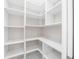 Bright walk-in pantry with ample shelving for storage at 8030 Midnight Pass Rd, Sarasota, FL 34242
