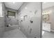 Large walk-in shower with marble tile and built-in bench at 8030 Midnight Pass Rd, Sarasota, FL 34242