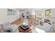 Open concept sitting area with hardwood floors and stylish armchairs at 8030 Midnight Pass Rd, Sarasota, FL 34242