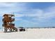 Beach with lifeguard stand, people enjoying the sun, and clear water at 4507 106Th W St, Bradenton, FL 34210