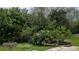 Landscaped backyard with circular stone border and bird bath at 8454 Imperial Cir, Palmetto, FL 34221