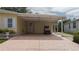 Covered carport with golf cart and spacious parking area at 8454 Imperial Cir, Palmetto, FL 34221