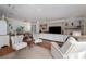 Bright living room featuring comfortable seating, built-in shelving, and a large TV at 8454 Imperial Cir, Palmetto, FL 34221