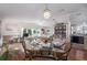 Open dining area with glass table and kitchen view at 8454 Imperial Cir, Palmetto, FL 34221