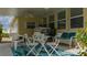 Patio with white furniture and teal rug, creating a relaxing space at 8454 Imperial Cir, Palmetto, FL 34221