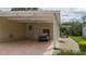 Covered carport with golf cart and side yard view at 8454 Imperial Cir, Palmetto, FL 34221