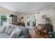 Living room with comfy sofa and access to sunroom at 8454 Imperial Cir, Palmetto, FL 34221