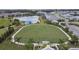 Aerial view of a community green space with palm trees and walking paths at 2783 Butterfly Jasmine Trl, Sarasota, FL 34240