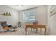 Home office featuring a writing desk, mid-century chair, and large window at 1959 Hibiscus St, Sarasota, FL 34239