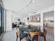 Dining area with large round marble table and modern chairs, adjacent to kitchen at 988 Blvd Of The Arts # 1712, Sarasota, FL 34236