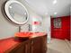 Stylish bathroom with a red tiled shower and modern vanity at 988 Blvd Of The Arts # 1712, Sarasota, FL 34236