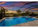 Enclosed pool and spa with lounge seating and sunset views at 3717 Savanna Palms Ct, Lakewood Ranch, FL 34211