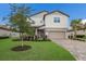 Two-story house with landscaping, stone driveway, and palm trees at 3717 Savanna Palms Ct, Lakewood Ranch, FL 34211