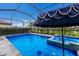 Pool area with spa and patio umbrella at 3717 Savanna Palms Ct, Lakewood Ranch, FL 34211