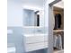 Modern bathroom with light blue vertical tiles and built-in closet at 2170 Robinhood Street # A4-304, Sarasota, FL 34231