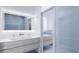 Elegant bathroom with double vanity and light blue tile at 2170 Robinhood Street # A4-102, Sarasota, FL 34231