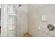 Shower with glass block wall and neutral-toned tile at 6462 Beechwood Ave, Sarasota, FL 34231