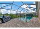 Screened pool area with brick pavers and grilling station at 2023 Mesic Hammock Way, Venice, FL 34292