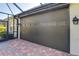 Exterior view of garage with dark brown roll-up door at 4808 Charles Partin Dr, Parrish, FL 34219
