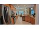 Modern kitchen with wood cabinets, granite countertops, and stainless steel appliances at 4808 Charles Partin Dr, Parrish, FL 34219