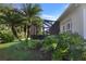 Landscaped backyard with lush greenery and screened enclosure at 4808 Charles Partin Dr, Parrish, FL 34219