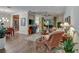 Bright living room with hardwood floors, wicker furniture, and access to kitchen and dining areas at 4808 Charles Partin Dr, Parrish, FL 34219