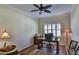 Bright home office with wood desk, chair, and plantation shutters at 4808 Charles Partin Dr, Parrish, FL 34219