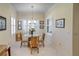 Charming breakfast nook with glass table and bamboo chairs, near kitchen at 4808 Charles Partin Dr, Parrish, FL 34219