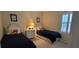 Charming bedroom with twin beds, ample closet space, and window shutters at 4808 Charles Partin Dr, Parrish, FL 34219