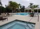Community pool with spa and lounge chairs at 4808 Charles Partin Dr, Parrish, FL 34219