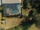 Aerial view of a screened pool with brick pavers and tropical plants at 1362 Hedgewood Cir, North Port, FL 34288
