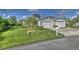 Charming single-story home featuring a manicured lawn and attached two-car garage at 1362 Hedgewood Cir, North Port, FL 34288