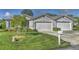 Charming single-story home featuring a manicured lawn and attached two-car garage at 1362 Hedgewood Cir, North Port, FL 34288
