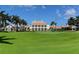 Large clubhouse with columns and manicured lawn at 393 N Point Rd # 302, Osprey, FL 34229