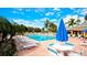 Community pool with lounge chairs and patio tables at 4480 Fairways Blvd # 109, Bradenton, FL 34209