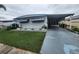 Single-wide manufactured home with carport and lawn at 5317 Chateau Ln, Bradenton, FL 34207