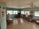 Living room with wicker furniture and large windows at 5317 Chateau Ln, Bradenton, FL 34207