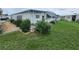White single-wide mobile home with landscaped yard and rock pathway at 5317 Chateau Ln, Bradenton, FL 34207