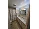 Bathroom with vanity, shower, and seashell-themed decor at 5317 Chateau Ln, Bradenton, FL 34207