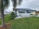 Single-wide manufactured home with landscaping at 5317 Chateau Ln, Bradenton, FL 34207