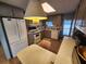 Eat-in kitchen with white appliances and taupe cabinets at 5317 Chateau Ln, Bradenton, FL 34207