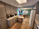 Kitchen with breakfast bar and view into living room at 5317 Chateau Ln, Bradenton, FL 34207