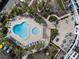 Aerial view of community pool, hot tub, seating areas, and lush landscaping of this complex at 5855 Midnight Pass Rd # 319, Sarasota, FL 34242