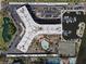 Overhead view of the complex, showcasing the building layout, pool, marina, parking, and tennis courts at 5855 Midnight Pass Rd # 319, Sarasota, FL 34242